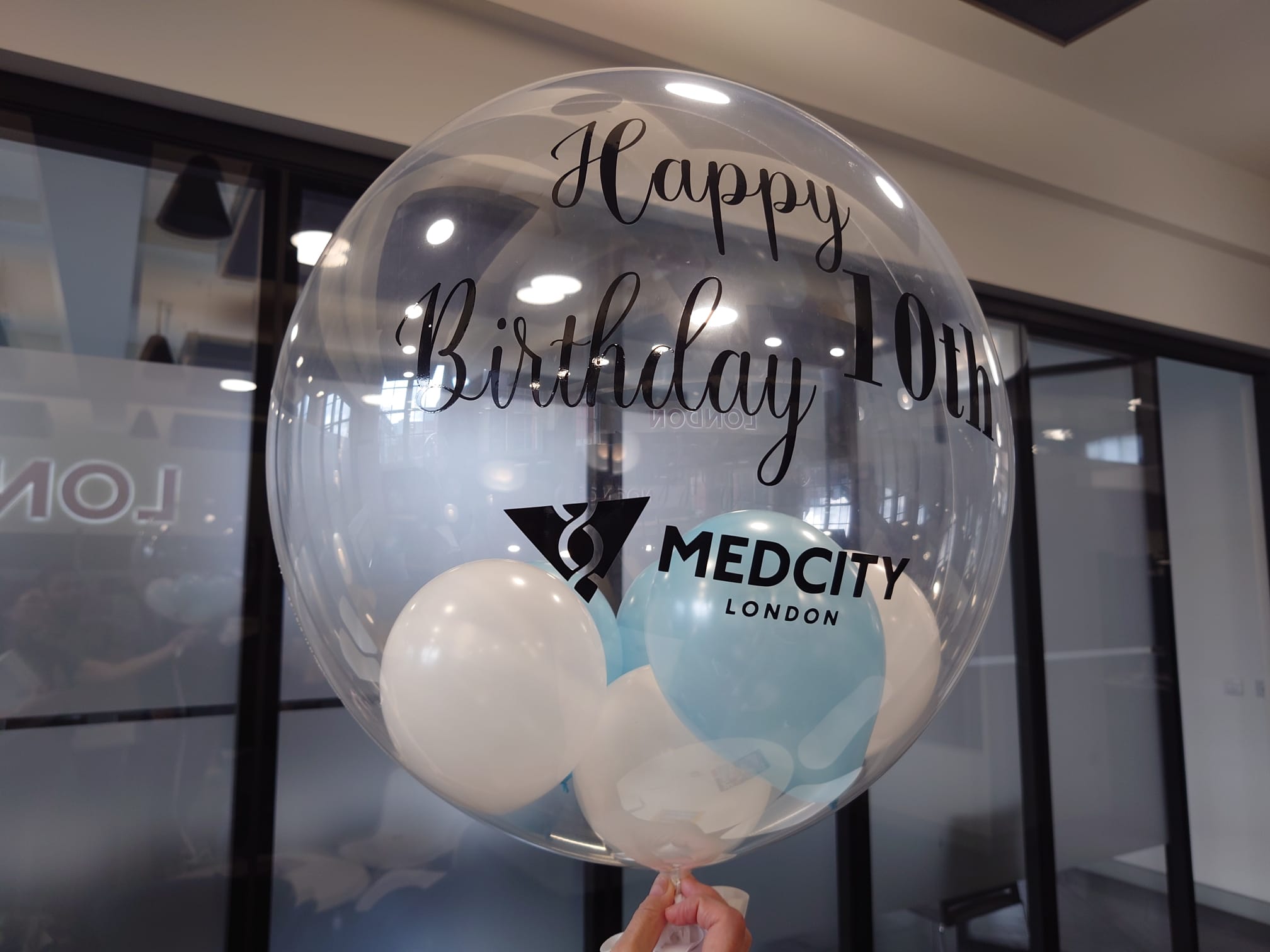 A large balloon with the text 'Happy 10th Birthday MedCity London' printed on it.